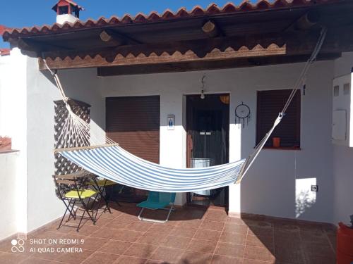 a hammock on the front of a house at El Corchuelo in Corteconcepción