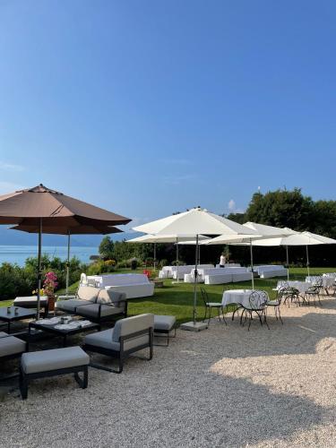 a group of tables and chairs with umbrellas at Villa Weiss in Attersee am Attersee