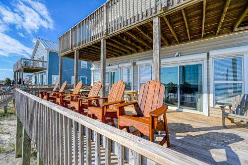 a group of chairs sitting on a deck with a house at Seashore's Best in North Topsail Beach