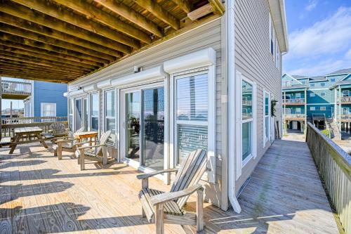 a deck with chairs and tables on a house at Seashore's Best in North Topsail Beach