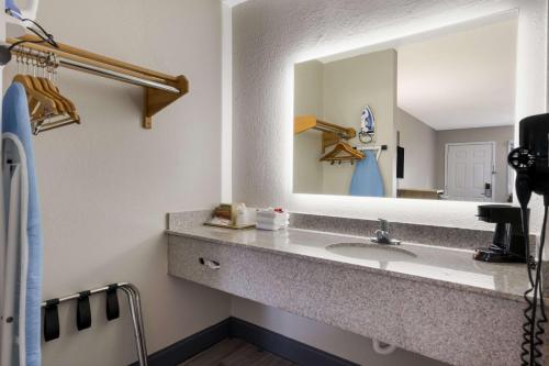 a bathroom with a sink and a mirror at SureStay Hotel by Best Western Spring North Houston in Spring