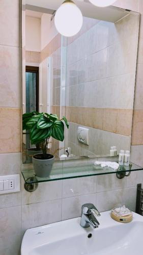 a bathroom with a sink and a mirror at Venice Suites in Mestre