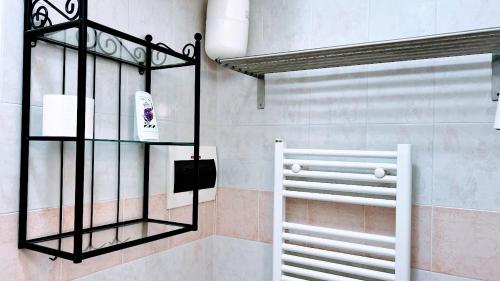 a bathroom with a towel rack and a window at Venice Suites in Mestre