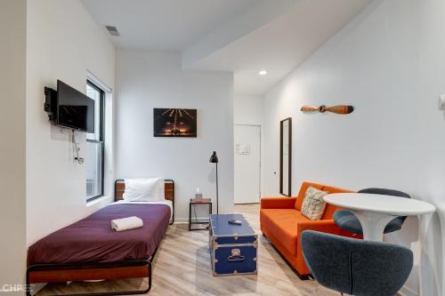 a living room with a couch and a table at Chicago Second Floor Studio by 747 Lofts in Chicago