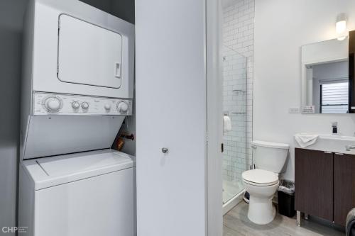 a white bathroom with a toilet and a sink at Chicago Second Floor Studio by 747 Lofts in Chicago