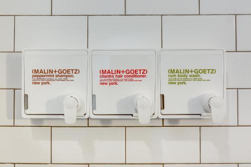 a row of white toilet paper dispensers on a wall at Chicago Second Floor Studio by 747 Lofts in Chicago
