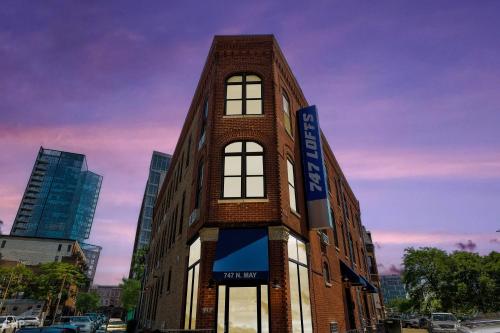 a tall brick building with a sign on it at Chicago Second Floor Studio by 747 Lofts in Chicago