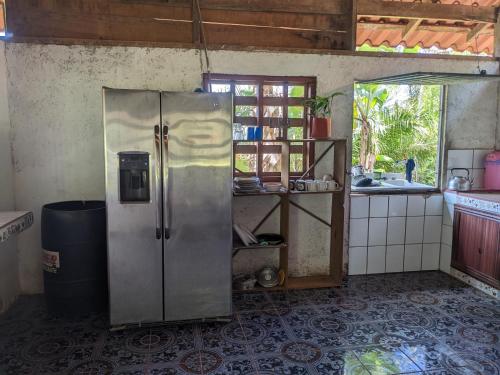 a kitchen with a stainless steel refrigerator and a window at La Katalinda in Drake