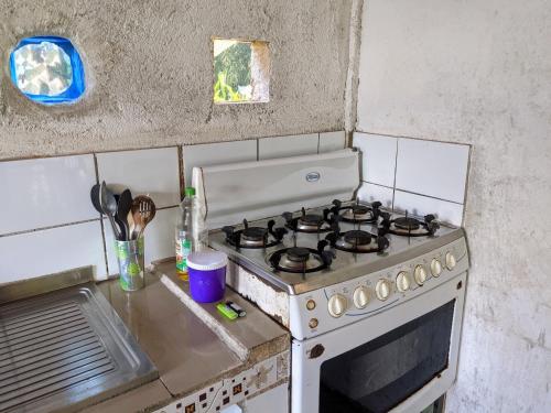 a kitchen with a stove top oven in a kitchen at La Katalinda in Drake
