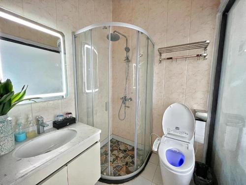 a bathroom with a shower and a toilet and a sink at Siargao Seasky Resort in Catagnan