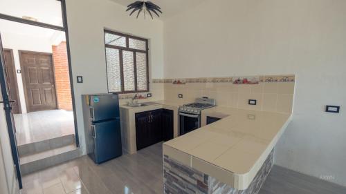 a kitchen with a blue refrigerator and a counter top at Villa Don Pedro - Casa de descanso in San Pedro La Laguna