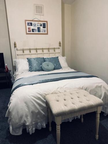 a bedroom with a large bed with a white comforter at Centrally located Double Bedroom in Leeds in Hunslet