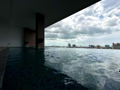 a swimming pool with a view of the city at The Apple Premier Condo in melaka in Malacca