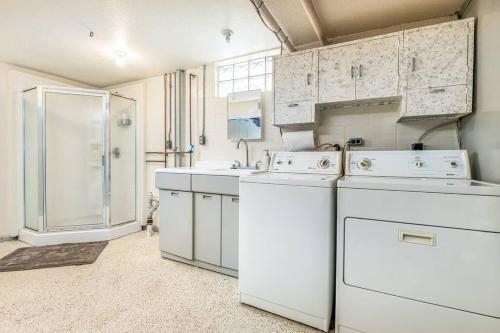 a laundry room with white appliances and a shower at Oaklie's Bungalow - Charming Home in Dubuque in Dubuque