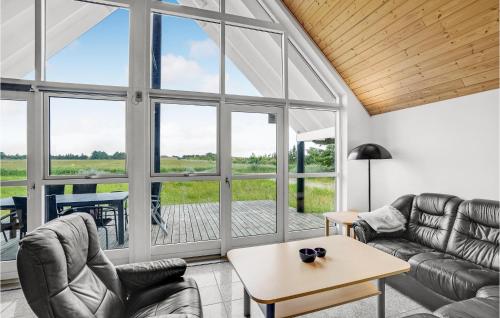 a living room with couches and a table at Holiday Home Nordstrup Xii in Rømø