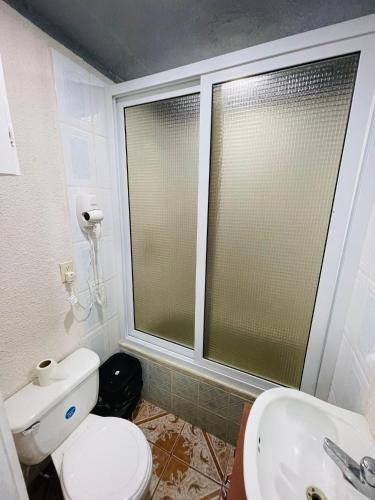 a bathroom with a toilet and a sink at Forest View Apartment in Six Huts
