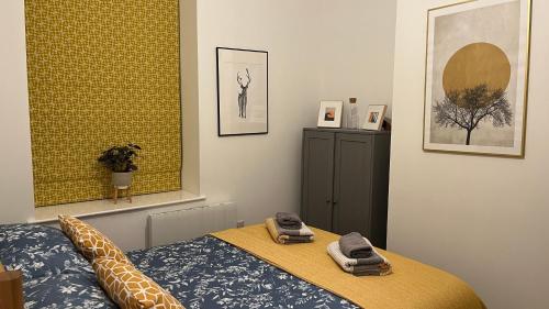 a bedroom with a bed with two towels on it at Brooklands Hideaway in Scarborough