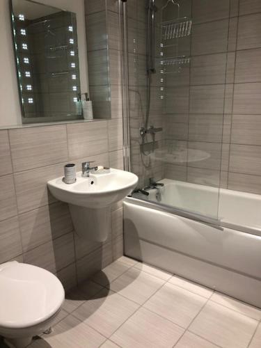 a bathroom with a sink and a toilet and a shower at Brooklands Hideaway in Scarborough