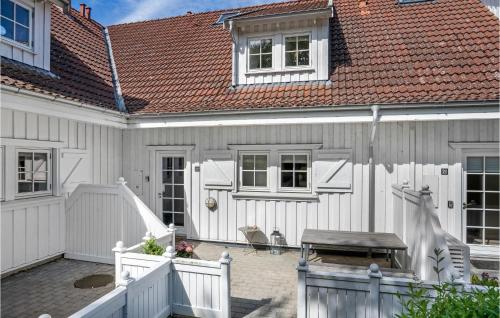 a white house with a white fence at Lake Front Apartment In Nykøbing Sj in Rørvig