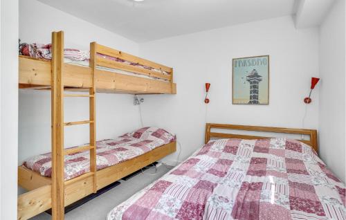 a bedroom with two bunk beds and a bed at Lake Front Apartment In Nykøbing Sj in Rørvig