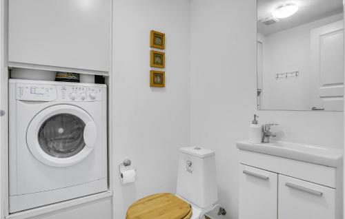 a white laundry room with a washing machine at Lake Front Apartment In Nykøbing Sj in Rørvig