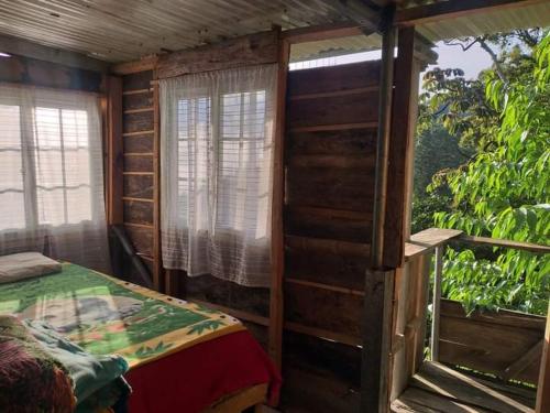 Habitación con cama y ventana. en Roots, en Valle Hornito