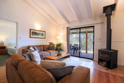 a living room with a couch and a wood stove at Donnelly Lakes in Pemberton