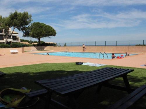 - une table de pique-nique en face de la piscine dans l'établissement Studio Cabine Mezzanine à Saint Pierre la Mer - 4 Couchages, Piscine, Terrasse, Parking Privé - FR-1-229D-313, à Saint Pierre La Mer