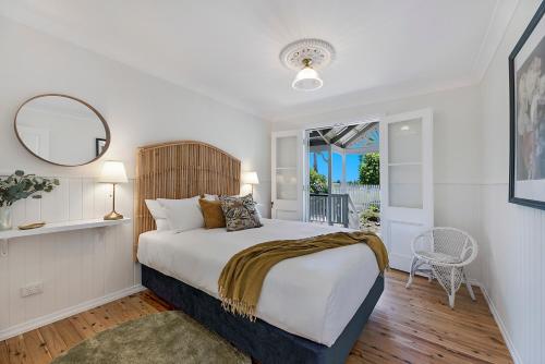 een slaapkamer met een groot bed en een spiegel bij Maleny Town Stay in Maleny