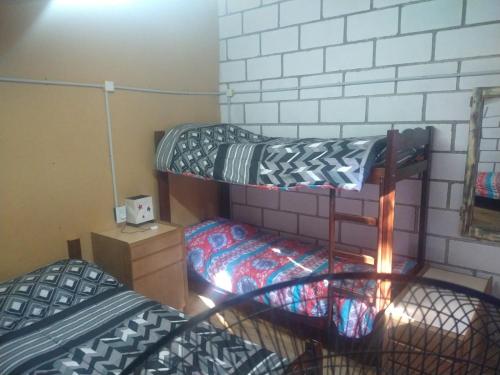 a dorm room with two bunk beds in it at cabañas rio y playa 2 in Atos Pampa