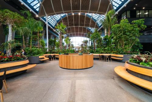 a large building with tables and chairs and plants at Crowne Plaza Copenhagen Towers by IHG in Copenhagen