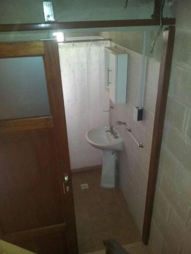 a small bathroom with a sink and a toilet at Cabañas Rio y Playa in Atos Pampa