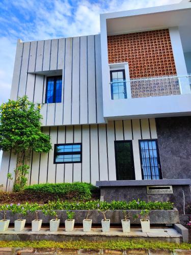 a building with plants in front of it at Beautiful House in City Centre in Kanggraksan