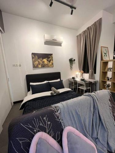 a bedroom with a bed with two chairs and a desk at Breeze Cottage@Empire Damansara in Petaling Jaya