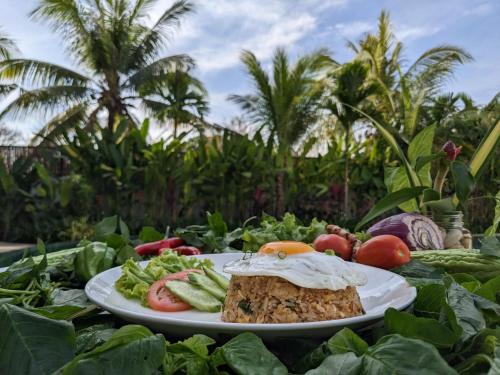 a plate of food on a table with vegetables at WAKA VILLA Private Pool Resort & Spa - Adults Only in Siem Reap