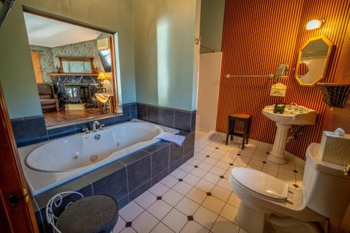 a bathroom with a tub and a toilet and a sink at Albergo Allegria Hotel & Breakfast Restaurant in Windham