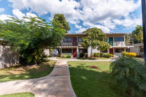 an exterior view of a house with a yard at Beach Apartment Villas Jubey, Emotion access in Juan Dolio
