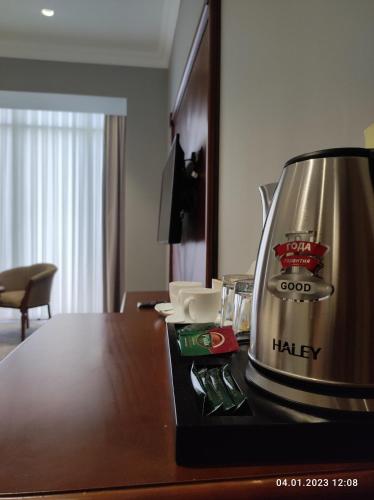 a coffee maker sitting on top of a table at Mir Luxe Plaza in Tashkent