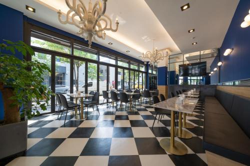 a restaurant with a checkered floor and tables and chairs at Wonju Central Hotel in Wonju