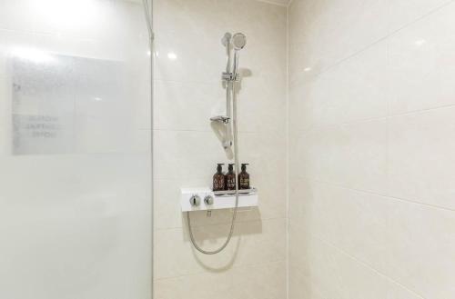 a shower with a shower head in a bathroom at Wonju Central Hotel in Wonju