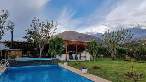 a house with a swimming pool in a yard at Huandoy Lodge - Huaraz in Yungay