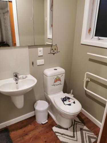 a bathroom with a toilet and a sink at Airport accommodation in Christchurch