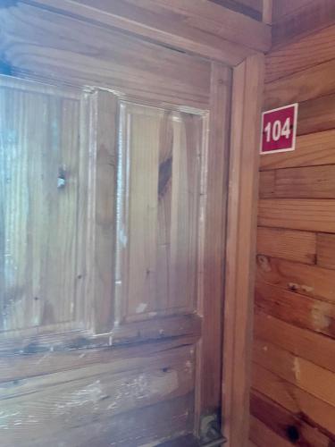 a wooden cabinet in a room with a sign on the wall at Cabañas el Chalet in Morelia