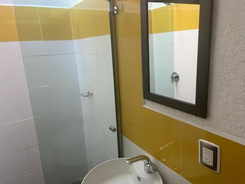 a bathroom with a sink and a mirror at Cabañas el Chalet in Morelia