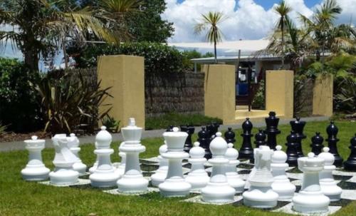 a large chess board in the grass with a large chessboardquarteredquarteredquarteredquartered at Kuituna on the Canal Villa, 3 bedrooms in Rotorua