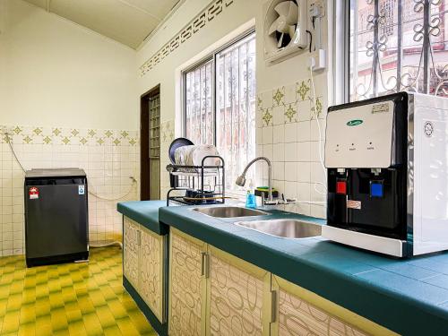 a kitchen with a sink and a microwave at Lake View 53 Heritage 4BR by LOUIS in Taiping