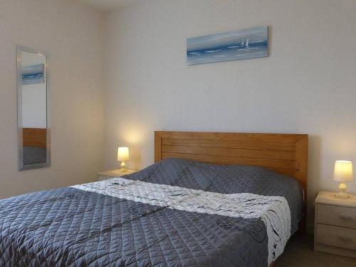 une chambre avec un lit avec deux tables de nuit et deux lampes dans l'établissement Agréable T2 à 1,5km du centre, proche plage, balcon, parking privé, ascenseur, 4 couchages - FR-1-224-447, à Saint-Gilles-Croix-de-Vie