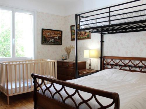 a bedroom with a bunk bed and a crib at Maison Saint-Trojan-les-Bains, 3 pièces, 5 personnes - FR-1-246A-353 in Saint-Trojan-les-Bains