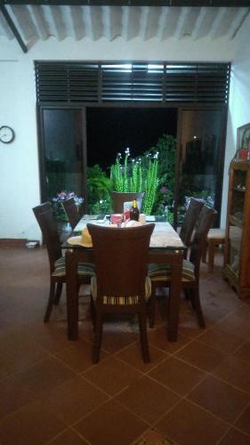 a dining table and chairs in a living room at Hostal posada San jose in San José de Suaita