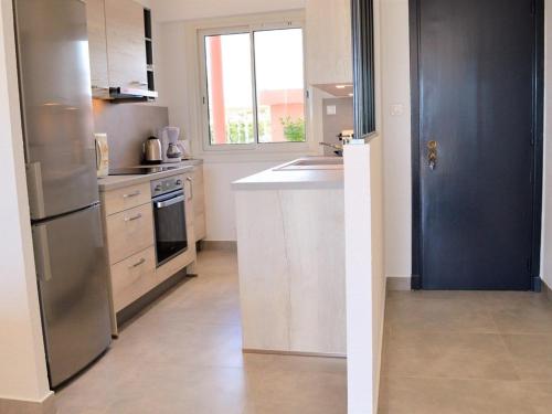 une cuisine avec un réfrigérateur en acier inoxydable et un évier dans l'établissement Appartement rénové en front de mer, 3 pièces, terrasse, parking, tout équipé, idéal familles, 6 pers. - FR-1-251-281, au Lavandou